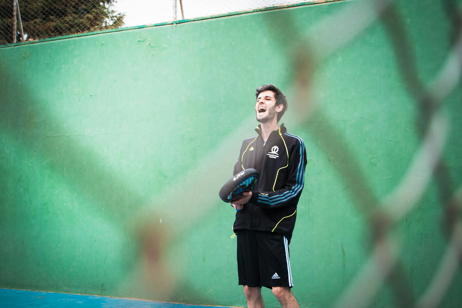 a man holding a tennis racquet on a tennis court